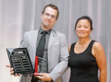 Jason Howlett of Current Millwork receiving the WorkSafeBC Safety Innovation Award from Rose MacDonald