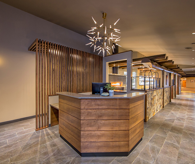 Reception desk with wood slat screen and stone, Tigh-Na-Mara Resort