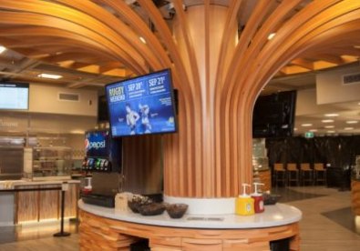 Curved wood ceiling and columns in a food service hall