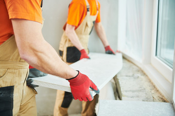 Installers fitting a solid surface panel